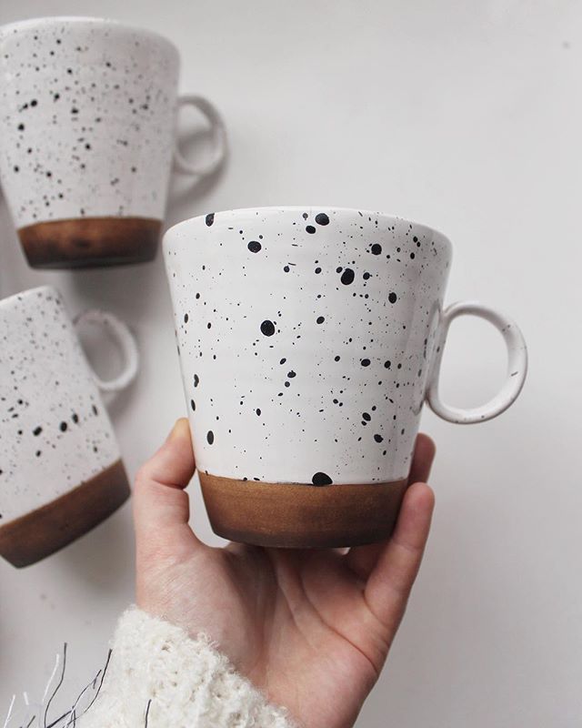 white mug with blacks spots 
