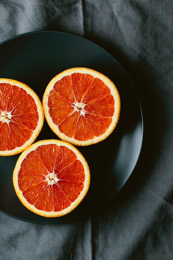 grapefruit slices on black plate