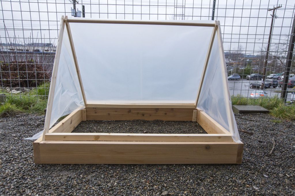 wooden and plastic wrap tent greenhouse